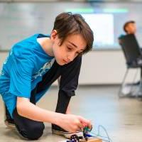 Student assembling robot car.